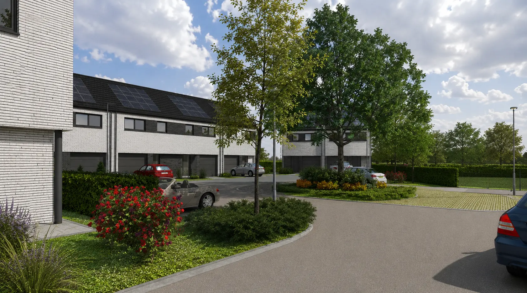 Perspective sur les garages et les jardins plantés des logements groupés