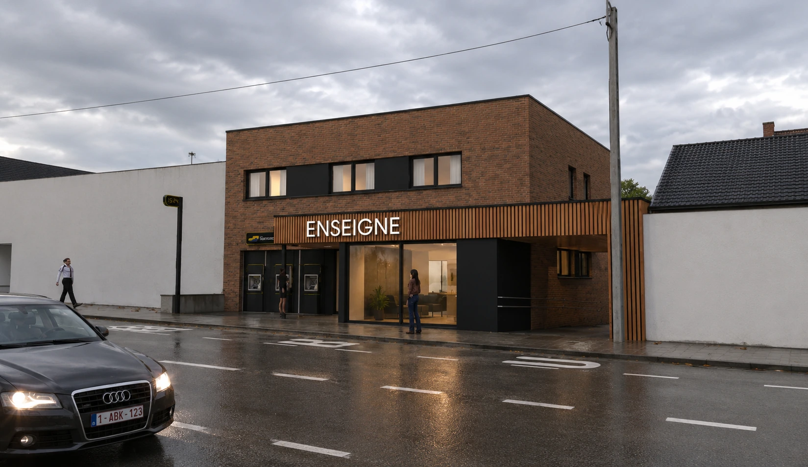 Vue frontale du bâtiment en soirée avec l'enseigne éclairée et les logements à l'étage